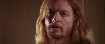 Movie still from “Pulp Fiction” (1994), directed by Quentin Tarantino – A person with long red hair; Close Up shot, Low angle