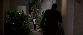 Movie still from “Pulp Fiction” (1994), directed by Quentin Tarantino – A man holding a towel while standing next to another man; Wide shot, Over the shoulder angle