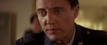 Movie still from “Pulp Fiction” (1994), directed by Quentin Tarantino – A man's face in a suit jacket; Close Up shot, Low angle