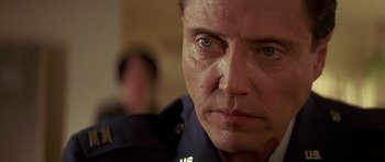 Movie still from “Pulp Fiction” (1994), directed by Quentin Tarantino – A man's face in a police uniform; Close Up shot, Low angle