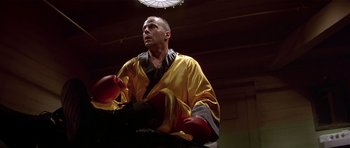 Movie still from “Pulp Fiction” (1994), directed by Quentin Tarantino – A man wearing a robe and boxing gloves; Medium shot, Low angle