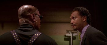 Movie still from “Pulp Fiction” (1994), directed by Quentin Tarantino – Two men talking to each other in front of a mirror; Close Up shot, Low angle