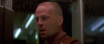 Movie still from “Pulp Fiction” (1994), directed by Quentin Tarantino – A man with a shaved head is looking to his left; Close Up shot, Low angle