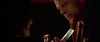 Movie still from “Pulp Fiction” (1994), directed by Quentin Tarantino – A man and a woman face to face in the dark; Close Up shot, Over the shoulder angle