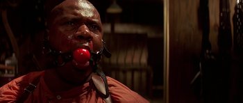 Movie still from “Pulp Fiction” (1994), directed by Quentin Tarantino – A man with a red ball in his mouth; Close Up shot, Low angle