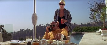 Movie still from “Pulp Fiction” (1994), directed by Quentin Tarantino – A man and a woman sitting at a dinner table; Medium shot, Low angle