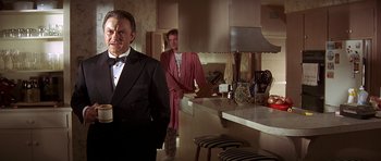 Movie still from “Pulp Fiction” (1994), directed by Quentin Tarantino – A man in a tuxedo standing next to a woman in a bathrobe; Medium shot, Over the shoulder angle