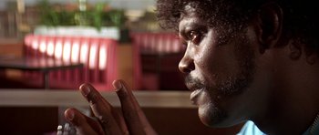 Movie still from “Pulp Fiction” (1994), directed by Quentin Tarantino – A person with his hands up; Close Up shot, Over the shoulder angle