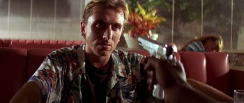 Movie still from “Pulp Fiction” (1994), directed by Quentin Tarantino – A person holding a gun; Close Up shot, Over the shoulder angle