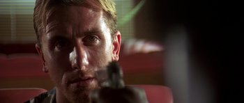 Movie still from “Pulp Fiction” (1994), directed by Quentin Tarantino – A person holding a gun in his hand; Close Up shot, Low angle