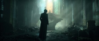 Movie still from “The Sandman” (2022), created by Neil Gaiman – A man standing in front of a stained glass window; Wide shot, Low angle