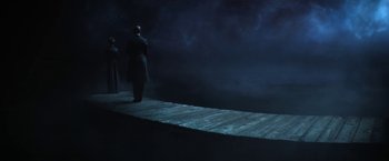 Movie still from “The Sandman” (2022), created by Neil Gaiman – A man standing on a dock at night; Extreme Wide shot, High angle