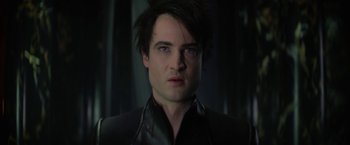Movie still from “The Sandman” (2022), created by Neil Gaiman – A person wearing a black jacket; Close Up shot, Low angle