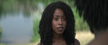 Movie still from “The Sandman” (2022), created by Neil Gaiman – A person wearing a necklace; Close Up shot, Over the shoulder angle