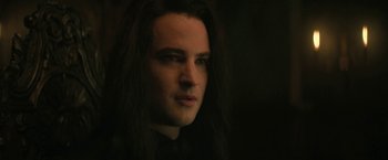 Movie still from “The Sandman” (2022), created by Neil Gaiman – A person with long black hair; Close Up shot, Over the shoulder angle