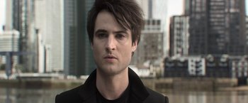 Movie still from “The Sandman” (2022), created by Neil Gaiman – A person wearing a black jacket; Close Up shot, Low angle