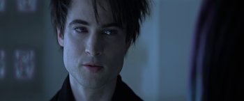 Movie still from “The Sandman” (2022), created by Neil Gaiman – A man's face in a dark room; Close Up shot, Over the shoulder angle