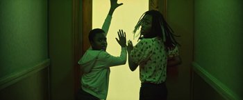 Movie still from “The Sandman” (2022), created by Neil Gaiman – Two young people are dancing in a green room; Medium shot, Low angle