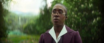 Movie still from “The Sandman” (2022), created by Neil Gaiman – A man in a purple jacket and white shirt; Close Up shot, Low angle