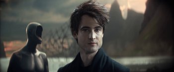 Movie still from “The Sandman” (2022), created by Neil Gaiman – A person wearing a black jacket; Close Up shot, Low angle
