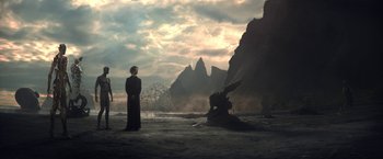 Movie still from “The Sandman” (2022), created by Neil Gaiman – A man standing in front of a rock formation; Extreme Wide shot, Low angle