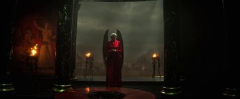 Movie still from “The Sandman” (2022), created by Neil Gaiman – A woman in a red robe sitting on a throne; Wide shot, High angle