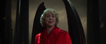 Movie still from “The Sandman” (2022), created by Neil Gaiman – A woman in a red robe with black wings; Medium shot, Low angle