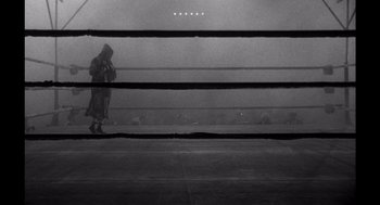 Movie still from “Raging Bull” (1980), directed by Martin Scorsese – A man is standing in a boxing ring in the fog; Wide shot, High angle