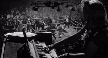 Movie still from “Raging Bull” (1980), directed by Martin Scorsese – An old piano in front of a boxing ring; Medium shot, High angle