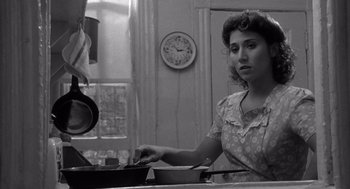 Movie still from “Raging Bull” (1980), directed by Martin Scorsese – A black and white photo of a woman cooking in a kitchen; Close Up shot, Low angle