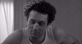 Movie still from “Raging Bull” (1980), directed by Martin Scorsese – Black and white photograph of a man with his eyes closed; Close Up shot, Over the shoulder angle