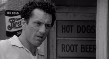 Movie still from “Raging Bull” (1980), directed by Martin Scorsese – A black and white photo of a man with curly hair; Close Up shot, Low angle