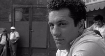 Movie still from “Raging Bull” (1980), directed by Martin Scorsese – Black and white photograph of a man with curly hair; Close Up shot, Low angle