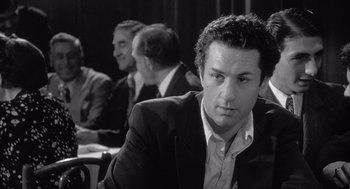 Movie still from “Raging Bull” (1980), directed by Martin Scorsese – Black and white photograph of a man in a suit; Close Up shot, Over the shoulder angle