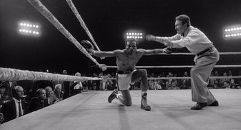 Movie still from “Raging Bull” (1980), directed by Martin Scorsese – A man in a boxing ring getting ready for a fight; Wide shot, Low angle