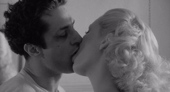 Movie still from “Raging Bull” (1980), directed by Martin Scorsese – A black and white photo of a man and a woman kissing; Close Up shot, Low angle