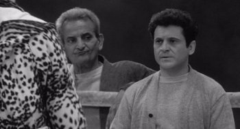 Movie still from “Raging Bull” (1980), directed by Martin Scorsese – Two men standing next to each other in front of a wall; Medium shot, Over the shoulder angle