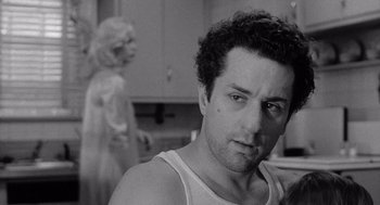 Movie still from “Raging Bull” (1980), directed by Martin Scorsese – A black and white photo of a man and a woman; Close Up shot, Over the shoulder angle
