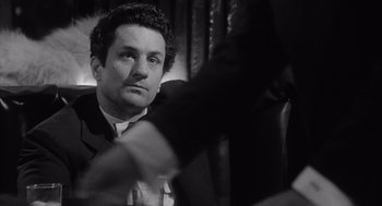 Movie still from “Raging Bull” (1980), directed by Martin Scorsese – Black and white photograph of a man in a suit; Close Up shot, Over the shoulder angle