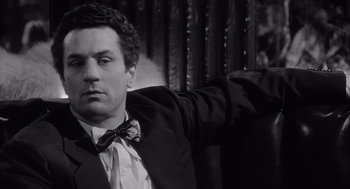 Movie still from “Raging Bull” (1980), directed by Martin Scorsese – A black and white photo of a man in a suit and bow tie; Close Up shot, Low angle