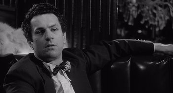 Movie still from “Raging Bull” (1980), directed by Martin Scorsese – Black and white photograph of a man wearing a suit and bow tie; Close Up shot, Low angle