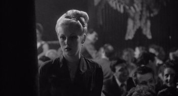 Movie still from “Raging Bull” (1980), directed by Martin Scorsese – A black and white photo of a woman in a crowd of people; Close Up shot, Low angle
