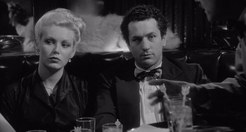 Movie still from “Raging Bull” (1980), directed by Martin Scorsese – A man and a woman sitting at a dinner table; Close Up shot, Low angle