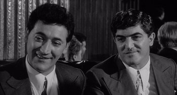 Movie still from “Raging Bull” (1980), directed by Martin Scorsese – A black and white photo of two men in suits and ties; Close Up shot, Low angle