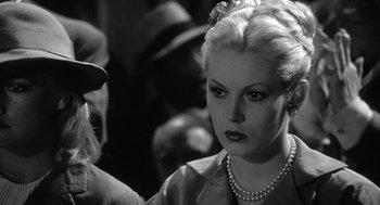 Movie still from “Raging Bull” (1980), directed by Martin Scorsese – An old photo of a woman with a pearl necklace; Close Up shot, Over the shoulder angle