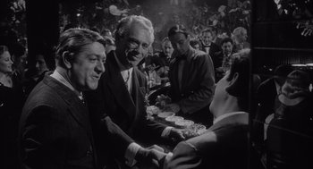 Movie still from “Raging Bull” (1980), directed by Martin Scorsese – A group of people sitting around a table; Medium shot, Over the shoulder angle