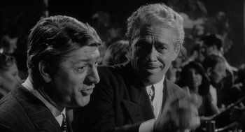 Movie still from “Raging Bull” (1980), directed by Martin Scorsese – A black - and - white photo of two men in suits; Close Up shot, Over the shoulder angle