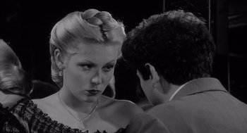Movie still from “Raging Bull” (1980), directed by Martin Scorsese – A woman in a dress and a man in a suit; Close Up shot, Over the shoulder angle