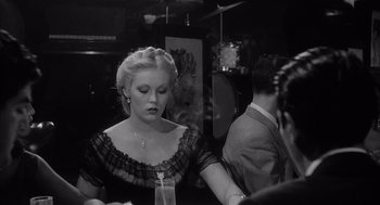 Movie still from “Raging Bull” (1980), directed by Martin Scorsese – A woman in a black and white photo with a man in a black suit; Close Up shot, Over the shoulder angle