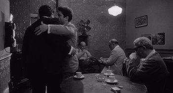 Movie still from “Raging Bull” (1980), directed by Martin Scorsese – A group of people hugging in a room; Wide shot, Over the shoulder angle